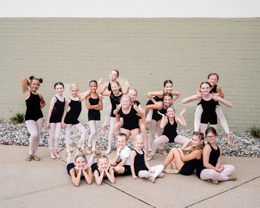 Dancers posing in a group outside studio